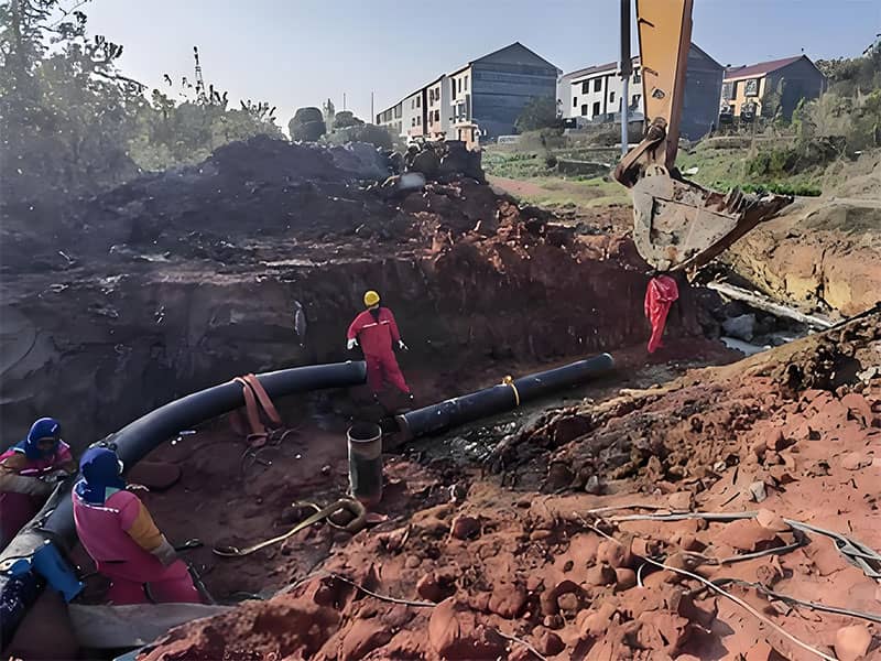 Excavation of a deep, precise trench for the new GA1 class L360M steel pipeline, with workers conducting alignment checks.