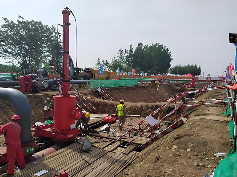 Workers operating equipment at the construction site of pipeline relocation project case study, part of abandoned pipeline disposal