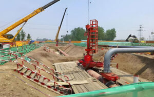 Construction site with plugging equipment and oil pipeline, part of abandoned pipeline disposal in pipeline hazard management project