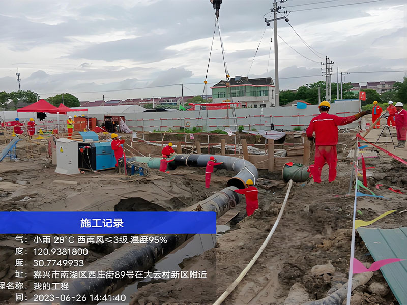 Workers arranging large crude oil pipes during pipeline relocation construction for integrity maintenance