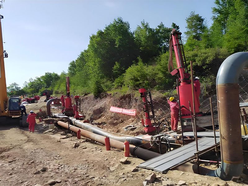 Worker performing welding during hot tapping and stoppling for live line pipeline repair on a coalbed methane pipeline (Shenmu-Anping project).