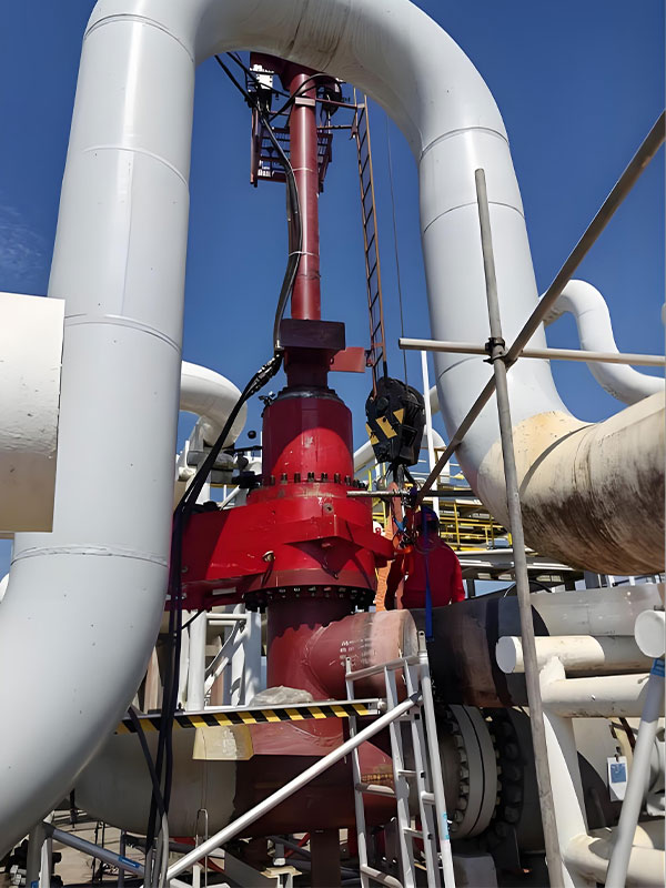 On-site Operation of Hot Tapping Equipment in EPC Pipeline Services Workers operating lifting gear to assist hot tapping equipment installation on high-pressure pipeline during EPC pipeline services
