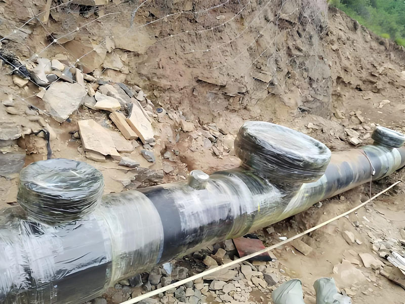 Construction team for onshore pipeline rehabilitation, holding recognition banners for hot tapping and stoppling work.
