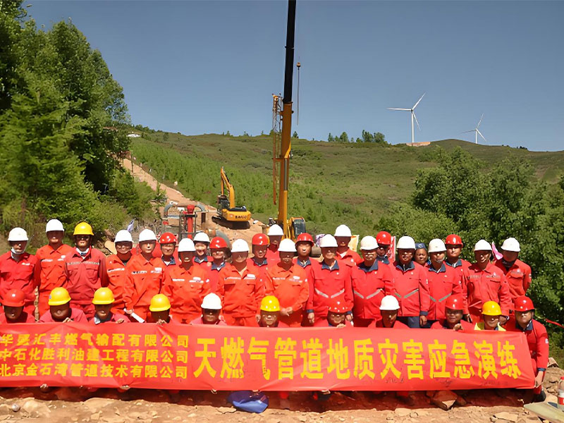 Workers performing welding for pipeline hot tapping during live line pipeline repair on a coalbed methane pipeline.