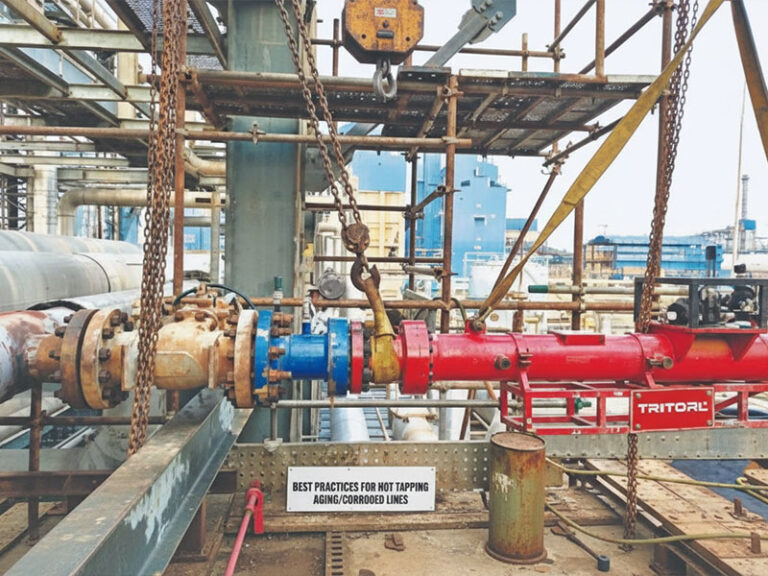 A TRITORL hot tapping machine setup on a corroded industrial pipeline in a refinery or power plant, demonstrating best practices for pipeline maintenance and repair.