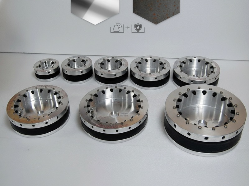 A collection of industrial modular pipe seals in various sizes, featuring silver metallic outer rings with bolts and thick black rubber gaskets for watertight sealing.