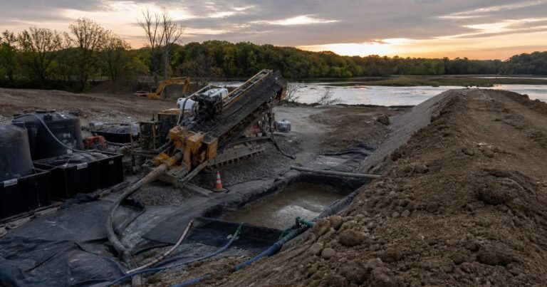 HDD rig drilling a pipeline crossing with drilling-fluid tanks and containment on site