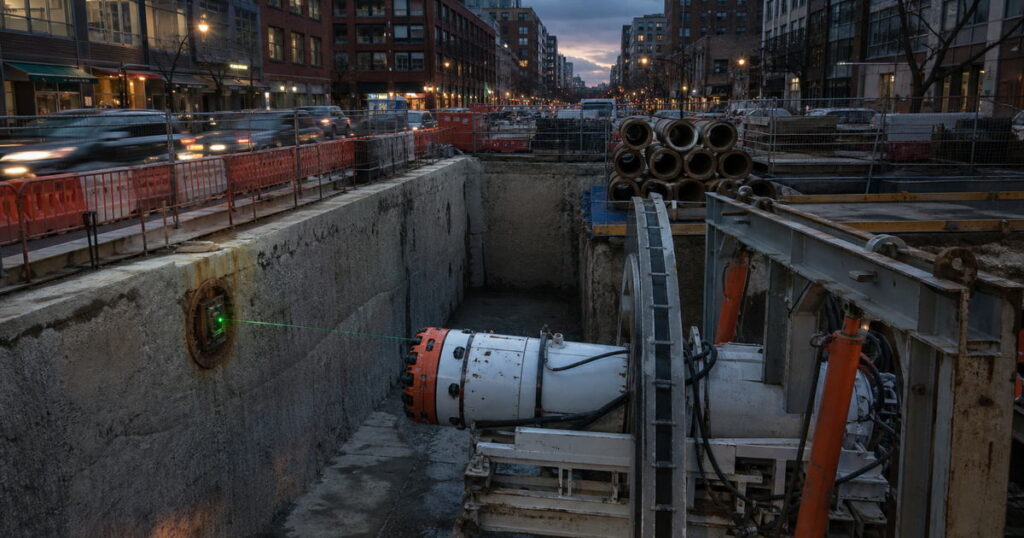 Guided microtunneling machine launching from an urban shaft to install a sanitary sewer at final line and grade