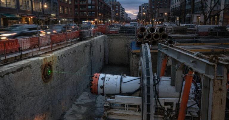 Guided microtunneling machine launching from an urban shaft to install a sanitary sewer at final line and grade